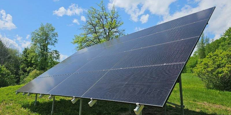 A ground-mounted solar array angled toward the sun in a grassy yard, an option ENS recommends when a roof cannot carry the panels.